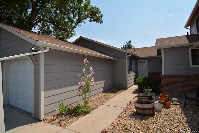 doorway to property with a garage