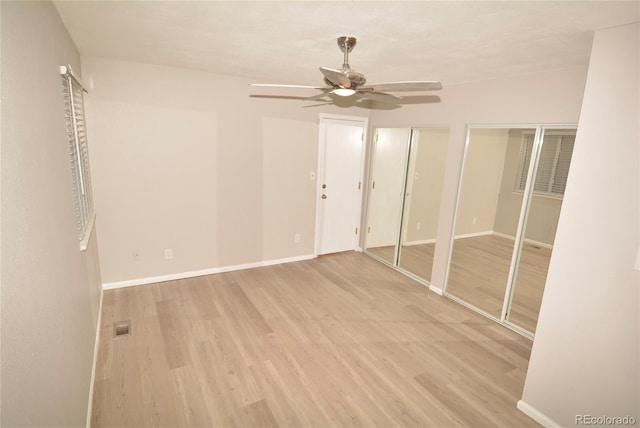 unfurnished room with ceiling fan and light hardwood / wood-style floors