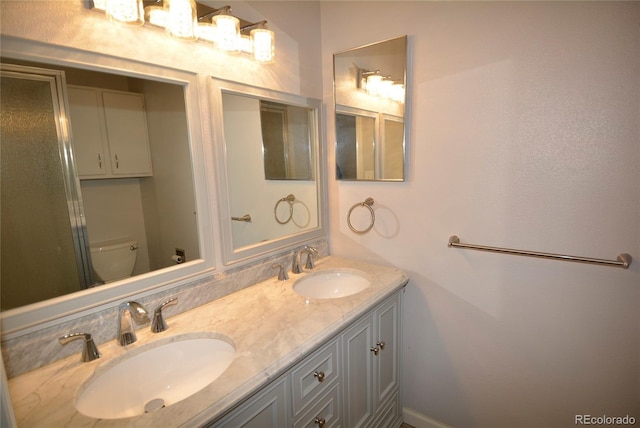 bathroom featuring vanity and toilet