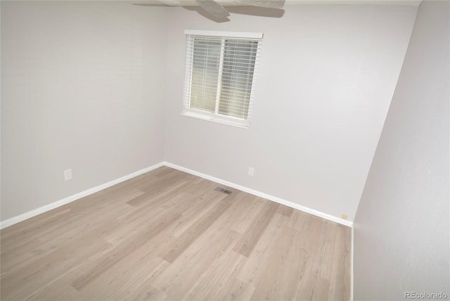 empty room with light hardwood / wood-style floors and ceiling fan