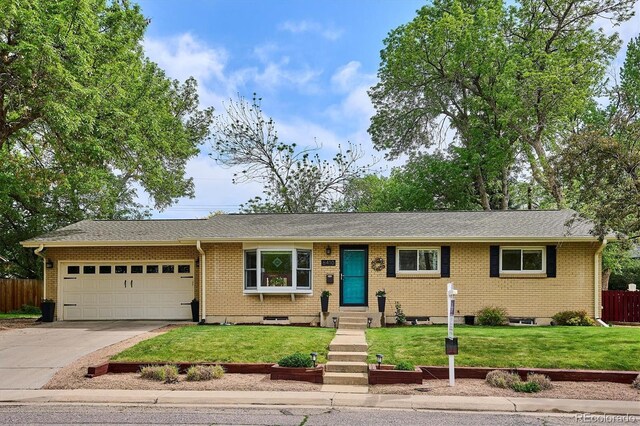 6410 Independence Way, Arvada, CO 80004 - single story home with a garage, driveway, brick siding, and roof with shingles