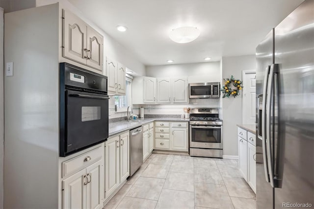 6410 Independence Way, Arvada, CO 80004 - kitchen featuring stainless steel appliances, a sink, backsplash, light stone counters, and recessed lighting