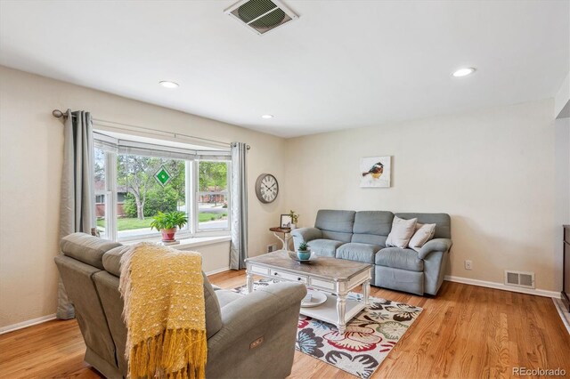 6410 Independence Way, Arvada, CO 80004 - living room with wood finished floors, baseboards, and recessed lighting