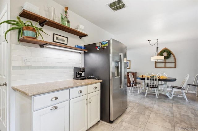 6410 Independence Way, Arvada, CO 80004 - kitchen featuring open shelves, stainless steel refrigerator with ice dispenser, white cabinetry, backsplash, and light tile patterned floors