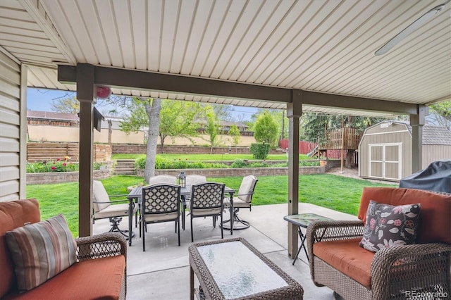 6410 Independence Way, Arvada, CO 80004 - view of patio / terrace with outdoor dining space, a storage unit, and an outdoor structure