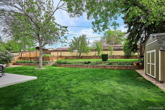 6410 Independence Way, Arvada, CO 80004 - view of yard featuring a storage shed, an outbuilding, and a patio
