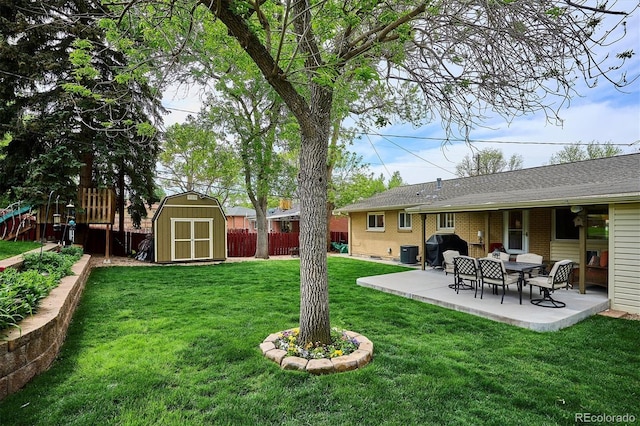 6410 Independence Way, Arvada, CO 80004 - view of yard with a shed, a patio, central AC unit, and an outbuilding