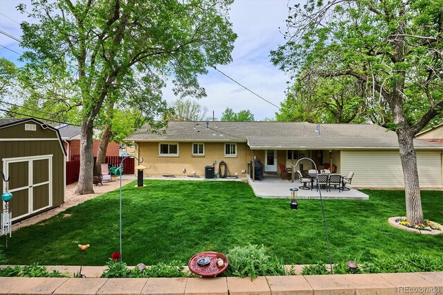 6410 Independence Way, Arvada, CO 80004 - rear view of house featuring a shed, a patio area, and an outbuilding