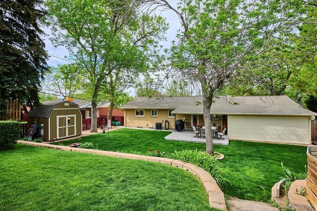 6410 Independence Way, Arvada, CO 80004 - back of property featuring a storage unit, a patio area, and an outbuilding