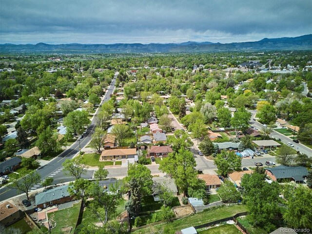 6410 Independence Way, Arvada, CO 80004 - aerial view of property and surrounding area with a mountainous background and nearby suburban area