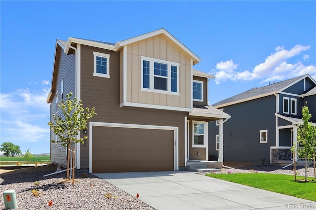 737 Muturu Rd, Johnstown, CO 80534 - view of front of home featuring board and batten siding, driveway, and an attached garage