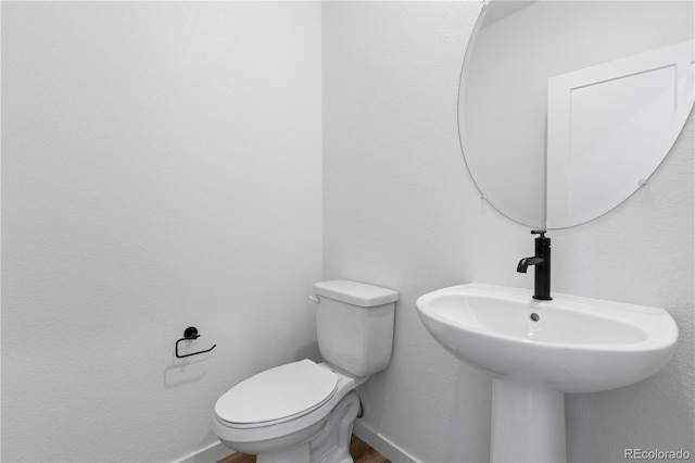 737 Muturu Rd, Johnstown, CO 80534 - bathroom featuring toilet, baseboards, and wood finished floors
