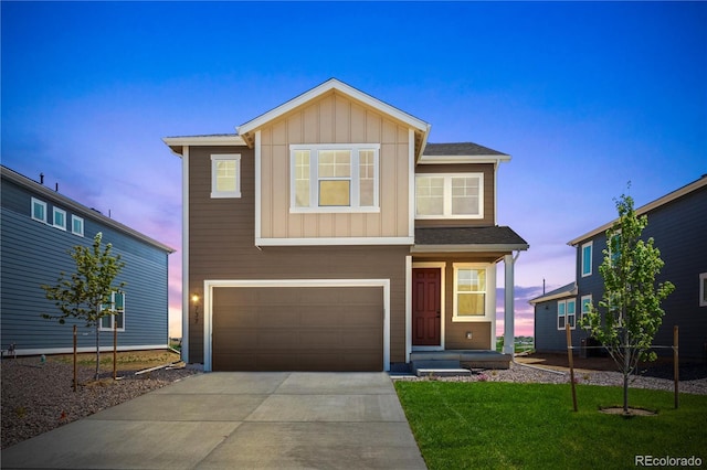 737 Muturu Rd, Johnstown, CO 80534 - view of front of property with board and batten siding, an attached garage, concrete driveway, and a front yard