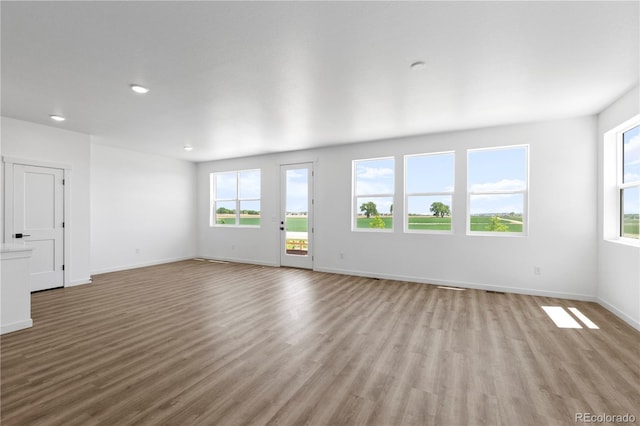 737 Muturu Rd, Johnstown, CO 80534 - unfurnished living room with wood finished floors, baseboards, and recessed lighting