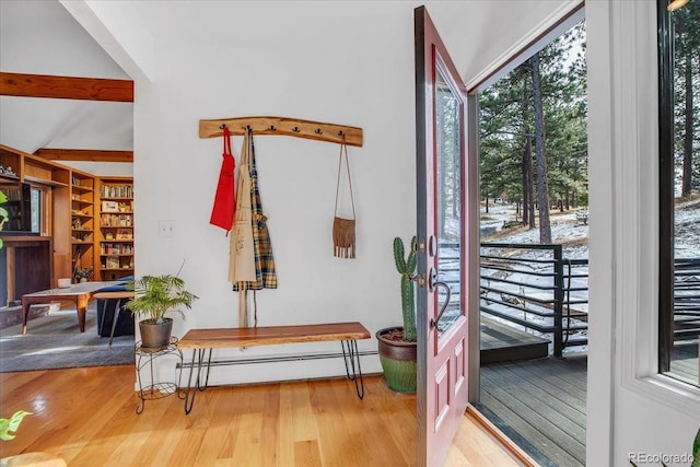 doorway featuring beam ceiling, a baseboard radiator, and wood finished floors