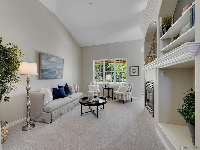 946 Champion Cir, Longmont, CO 80503 - living room with a tiled fireplace, baseboards, carpet, and high vaulted ceiling