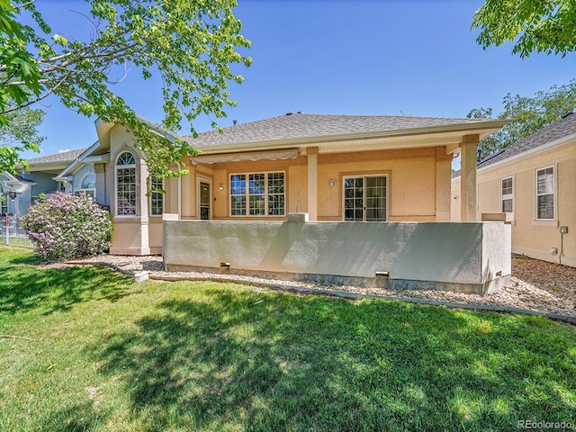 946 Champion Cir, Longmont, CO 80503 - rear view of house featuring stucco siding and a lawn