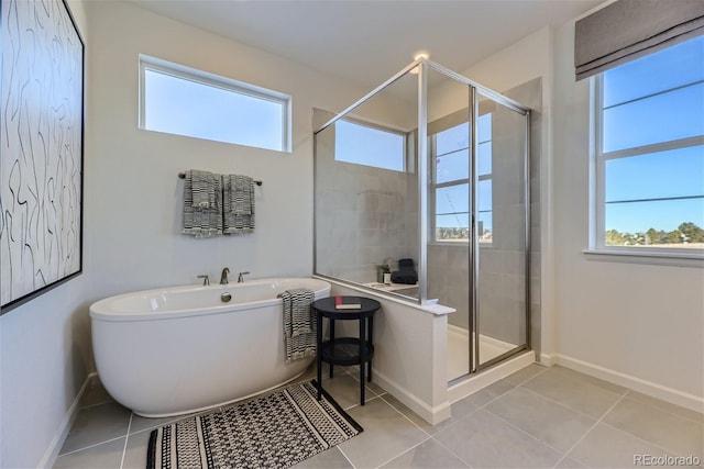 bathroom featuring plus walk in shower, tile patterned floors, and plenty of natural light