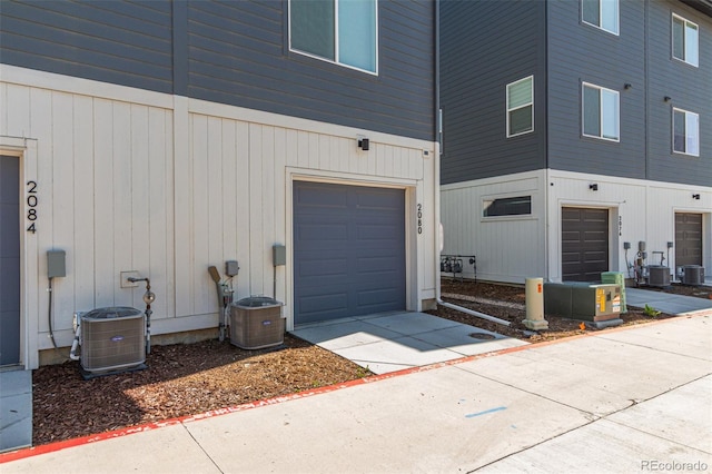 2080 Alcott Way, Broomfield, CO 80023 - view of exterior entry with a garage, central air condition unit, and driveway