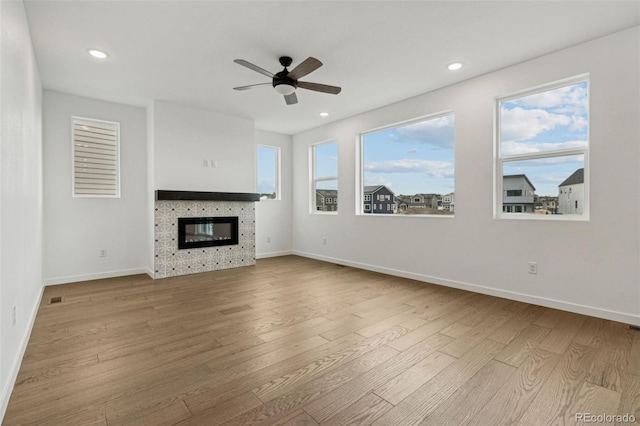 unfurnished living room featuring ceiling fan and light hardwood / wood-style floors