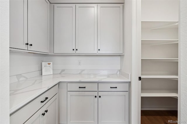 kitchen featuring light stone countertops and hardwood / wood-style floors