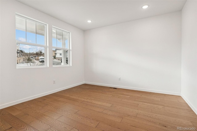 spare room with light wood-type flooring