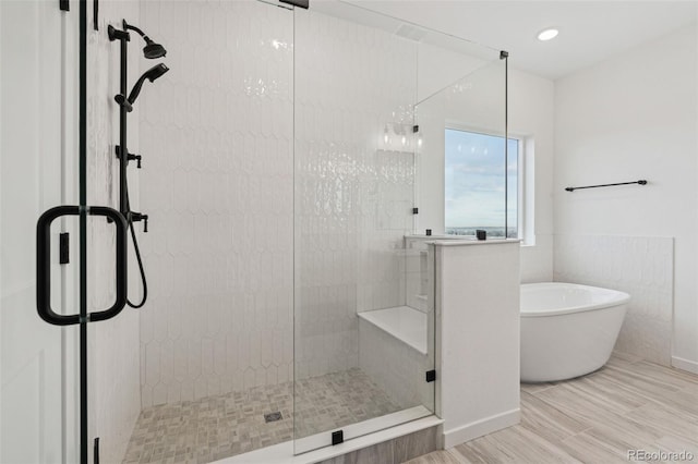 bathroom featuring separate shower and tub