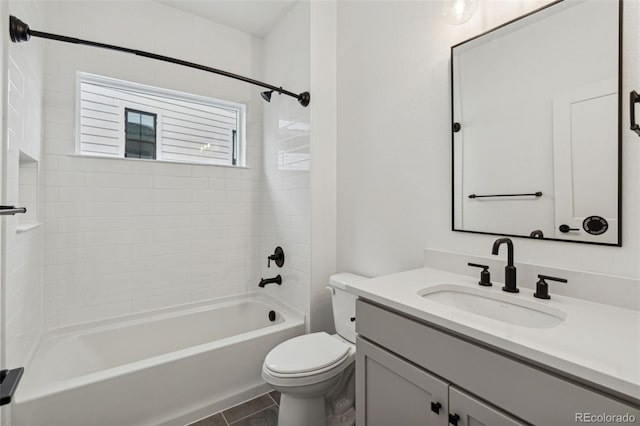 full bathroom featuring tile patterned flooring, vanity, toilet, and tiled shower / bath