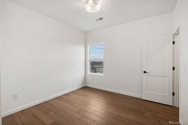 empty room featuring dark hardwood / wood-style flooring