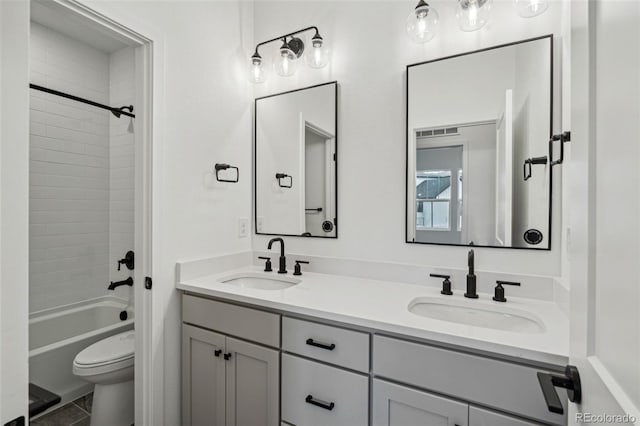 full bathroom with vanity, toilet, and tiled shower / bath