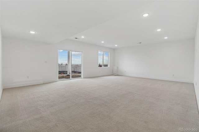 spare room featuring light colored carpet