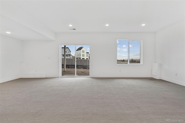 carpeted empty room featuring plenty of natural light