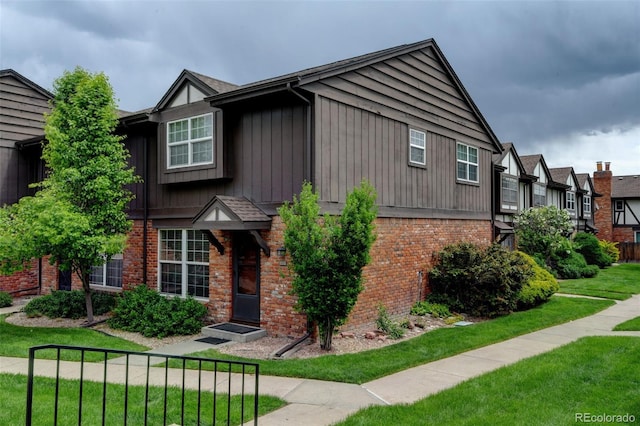 3855 S Monaco St Unit 177, Denver, CO 80237 - view of front of home with brick siding and a front lawn