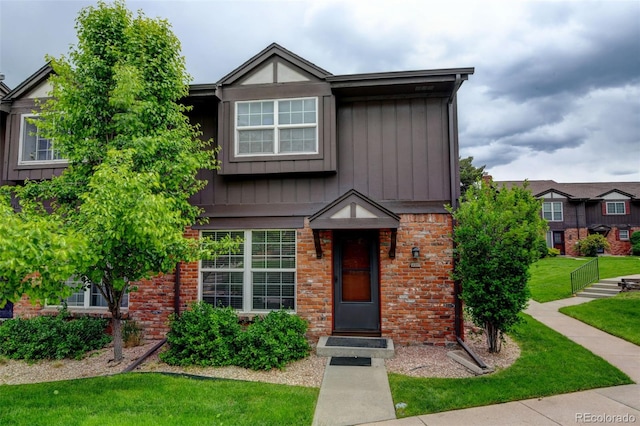 3855 S Monaco St Unit 177, Denver, CO 80237 - view of front facade featuring brick siding and a front yard