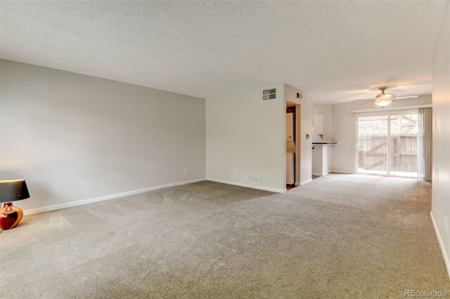 3855 S Monaco St Unit 177, Denver, CO 80237 - unfurnished living room with carpet flooring, ceiling fan, a textured ceiling, and baseboards