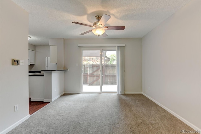 3855 S Monaco St Unit 177, Denver, CO 80237 - unfurnished living room featuring carpet, ceiling fan, a textured ceiling, and baseboards