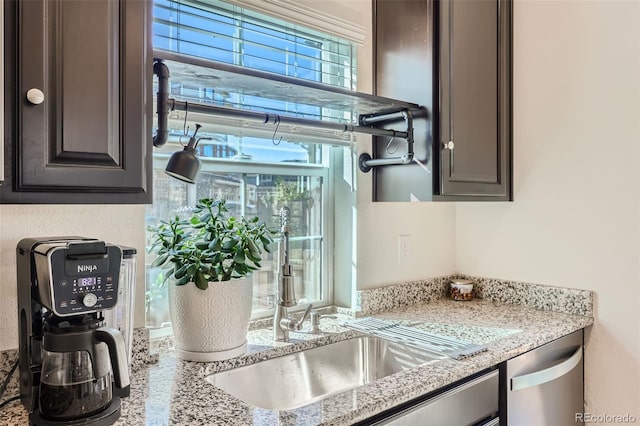 kitchen with light stone counters and stainless steel dishwasher