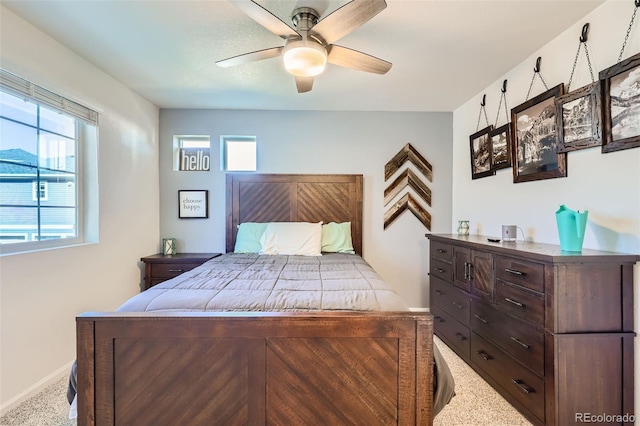 bedroom with ceiling fan and light colored carpet