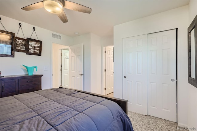 bedroom with ceiling fan, carpet floors, and a closet