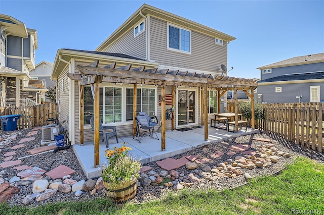 rear view of property featuring a pergola, a patio area, and cooling unit