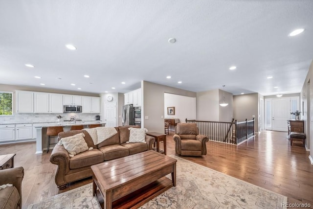 5865 Clover Ridge Cir, Castle Rock, CO 80104 - living area featuring light wood finished floors and recessed lighting