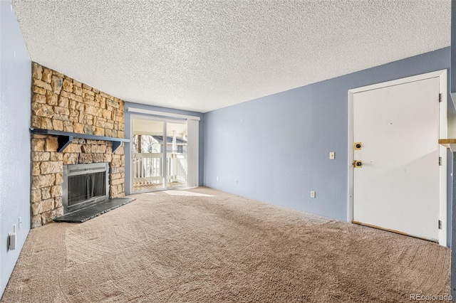 unfurnished living room featuring carpet, a fireplace, and a textured ceiling