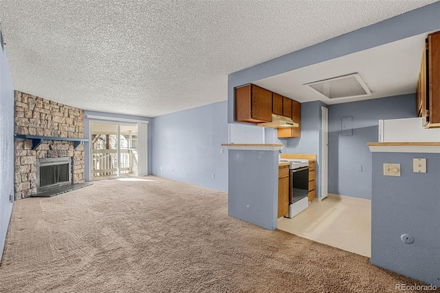 kitchen with a fireplace, light colored carpet, white electric range, a textured ceiling, and under cabinet range hood