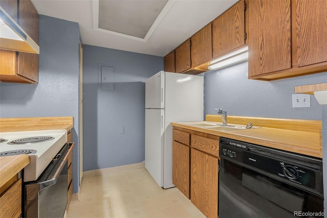 kitchen featuring white appliances, baseboards, extractor fan, light countertops, and a sink