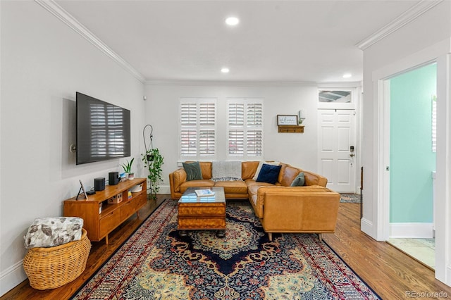 living area with ornamental molding, recessed lighting, baseboards, and wood finished floors