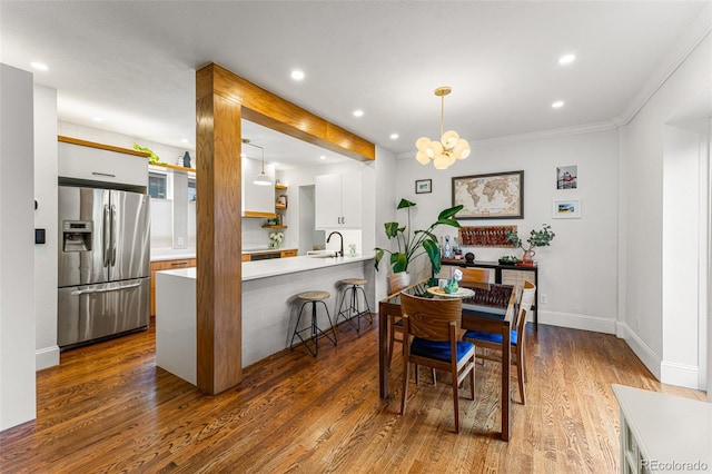 dining area with a chandelier, dark wood-style flooring, baseboards, and recessed lighting