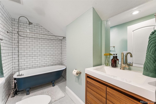 bathroom with toilet, a soaking tub, tile patterned flooring, vaulted ceiling, and vanity