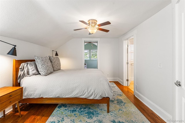 bedroom with vaulted ceiling, ceiling fan, dark wood finished floors, and baseboards