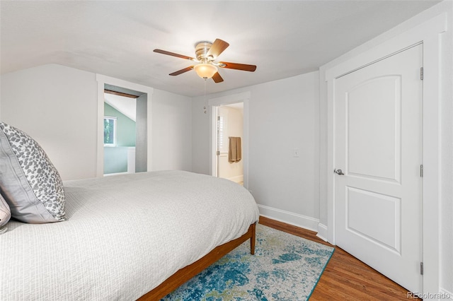 bedroom with a ceiling fan, lofted ceiling, baseboards, and wood finished floors