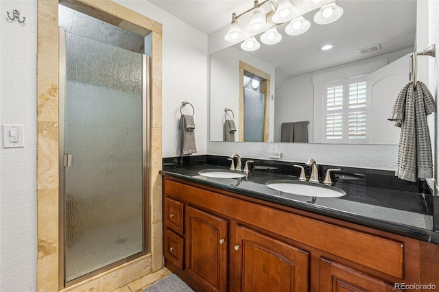 bathroom featuring a shower stall, visible vents, and a sink